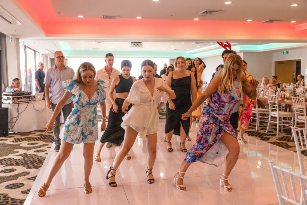 Team members participating in a dance activity at a company event in Wollongong